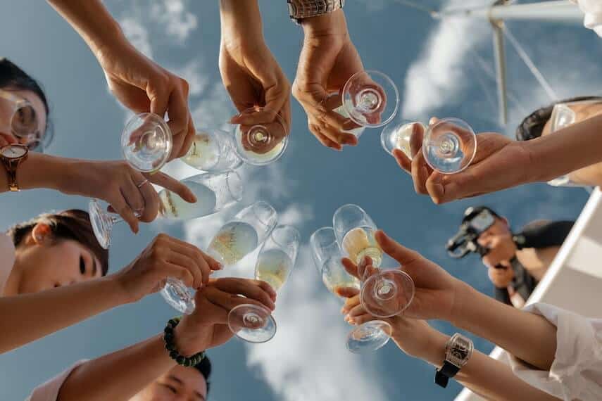 Group of friends cheers with Champagne flutes