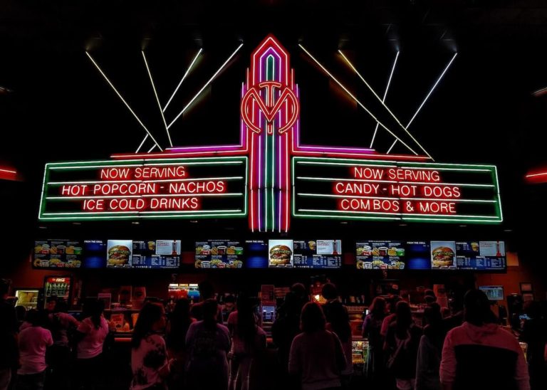 90s Movie Trivia Quiz Questions and Answers Cover Photo of a neon cinema board advertising popcorn and hot dogs