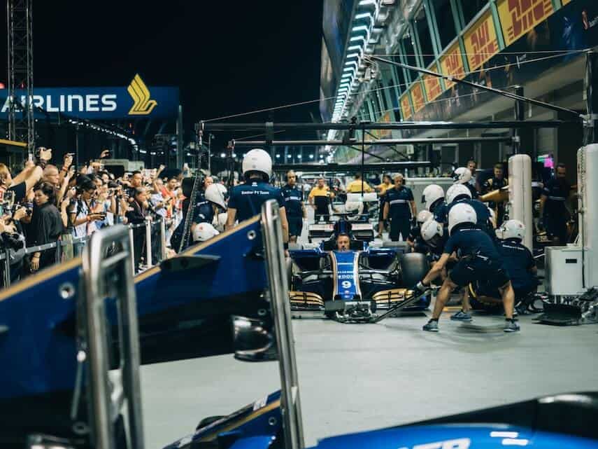 Busy pit lane at night at the Singapore Grand Prix