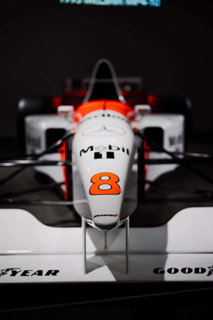Close up shot, front on, of a white Mercedes F1 car with red accents