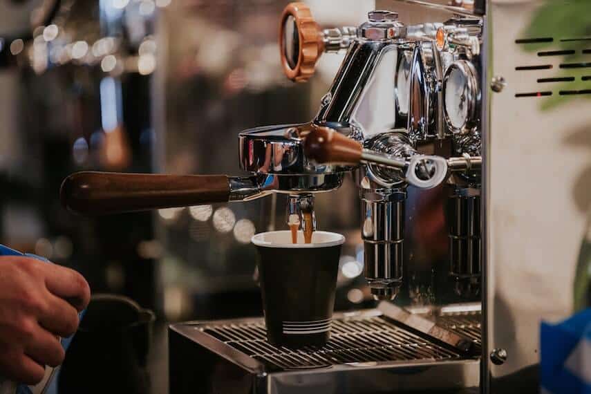 Silver coffee machine making two cups of coffee