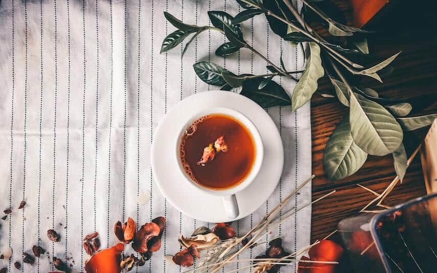 Cup of tea with flower petals floating on top