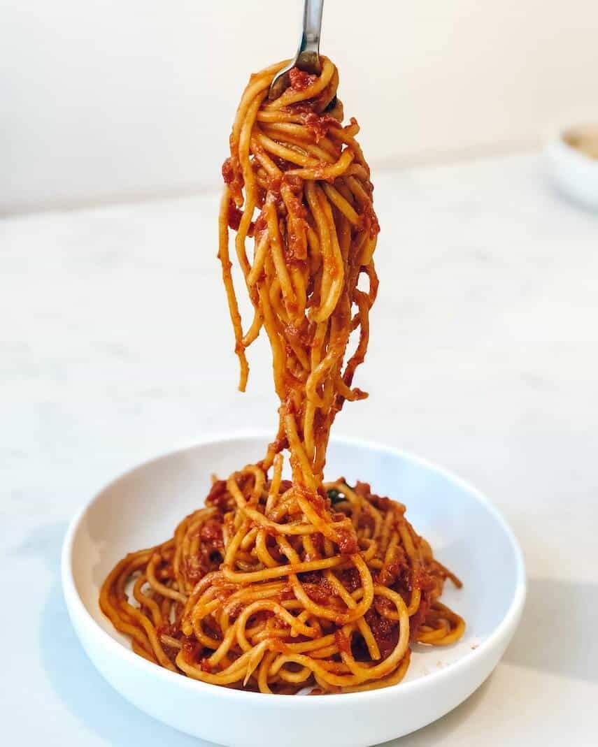 Spaghetti Bolognaise in a bowl being twirled on a fork