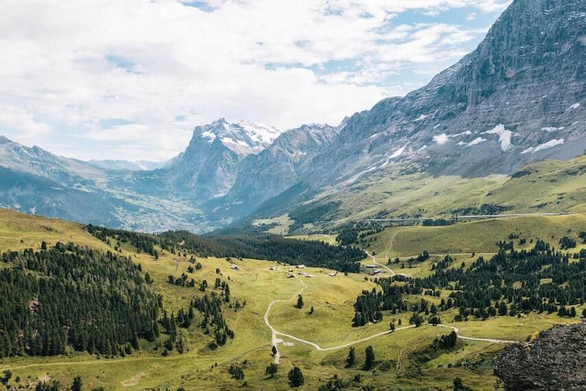 Switzerland - rolling green hills with mountains in the background