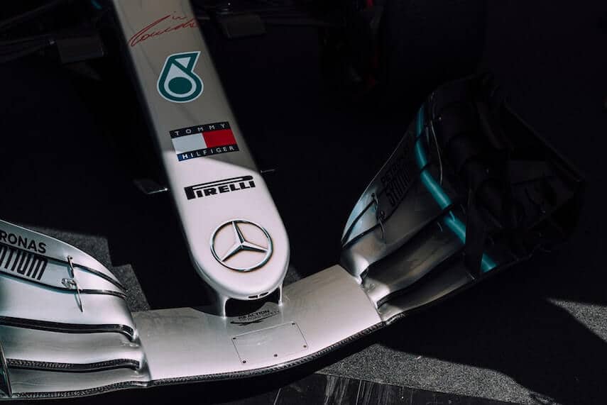 The front of a Mercedes F1 Raceing Car with Pirella, Tommy Hilfiger and Petronas sponsor stickers