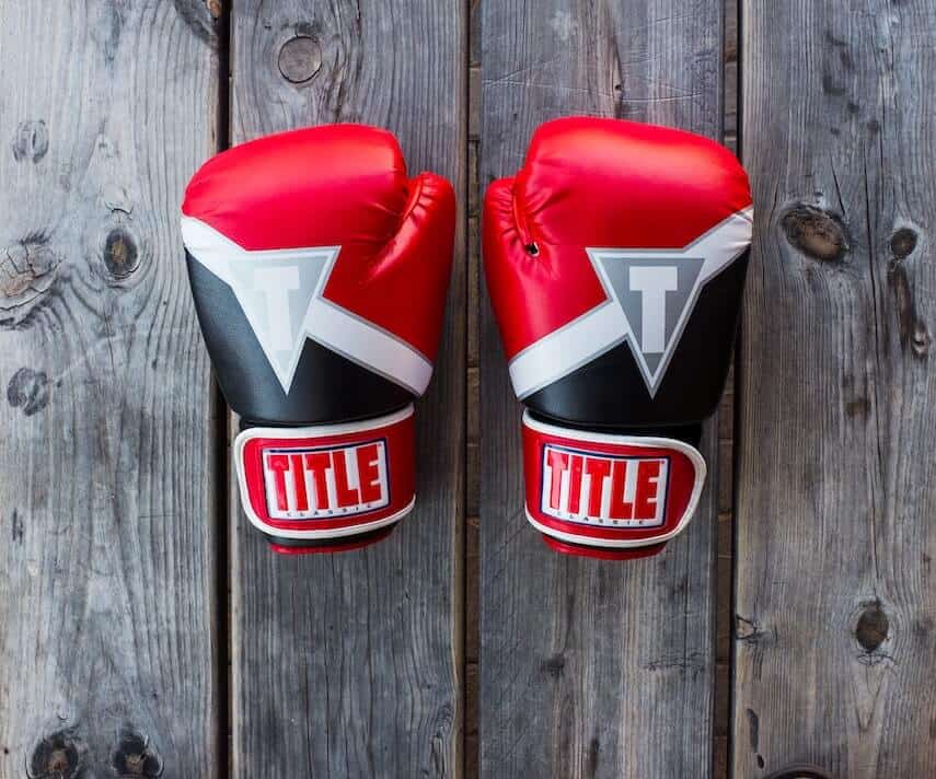 Top down shot of Red and Black boxing gloves on a wooden bench