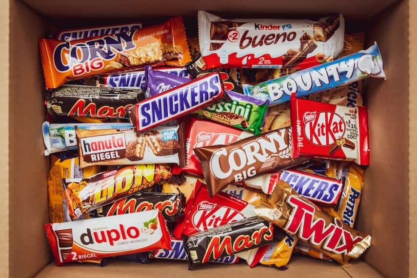 Box of different milk chocolate bars including mars, kit kat, snickers, lion, bounty, kinder bueno