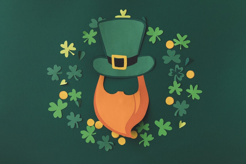 Leprechaun beard and hat surrounded by shamrocks and gold coins