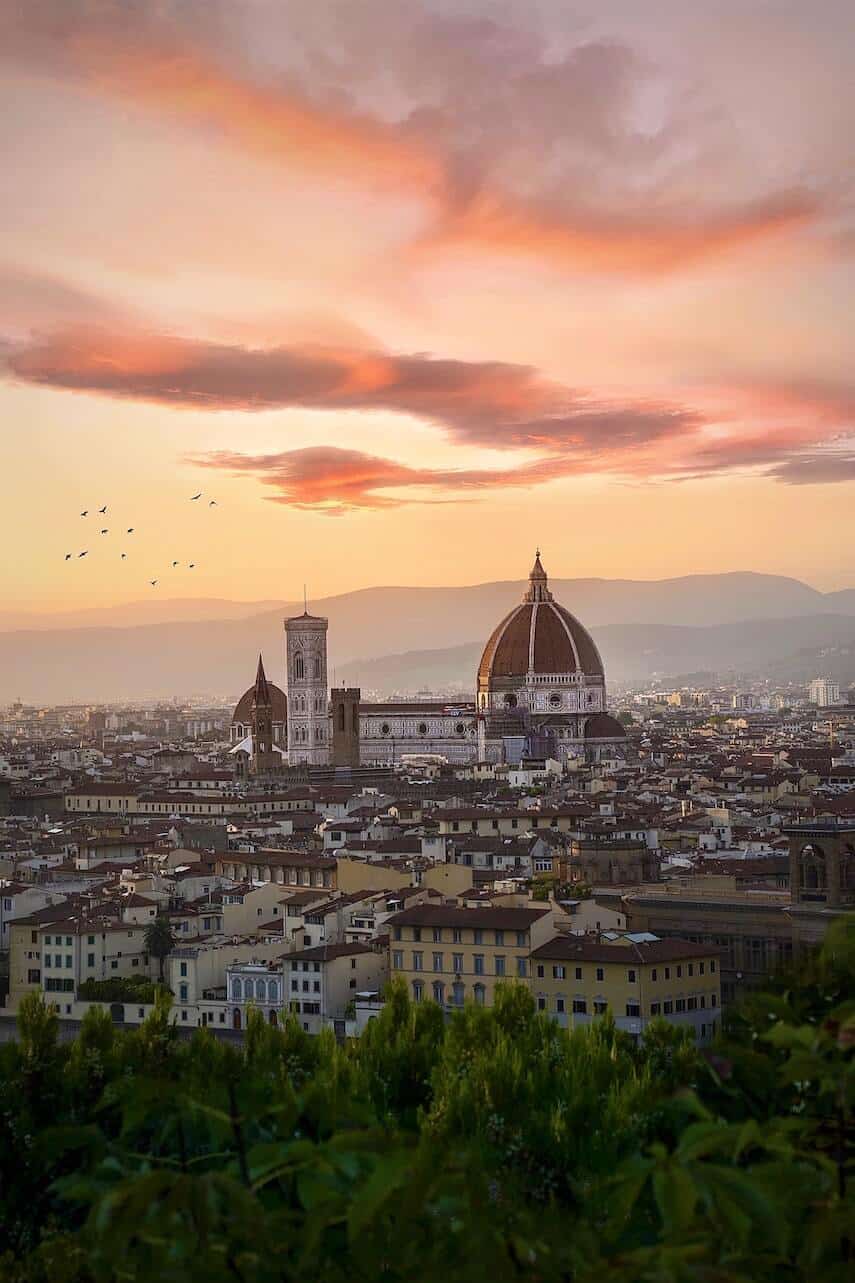 Skyline of Florence, with the Duomo at the centre under a pink sunset sky
