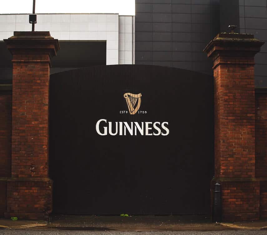 Wooden Gate painted black with the Guinness logo at the centre