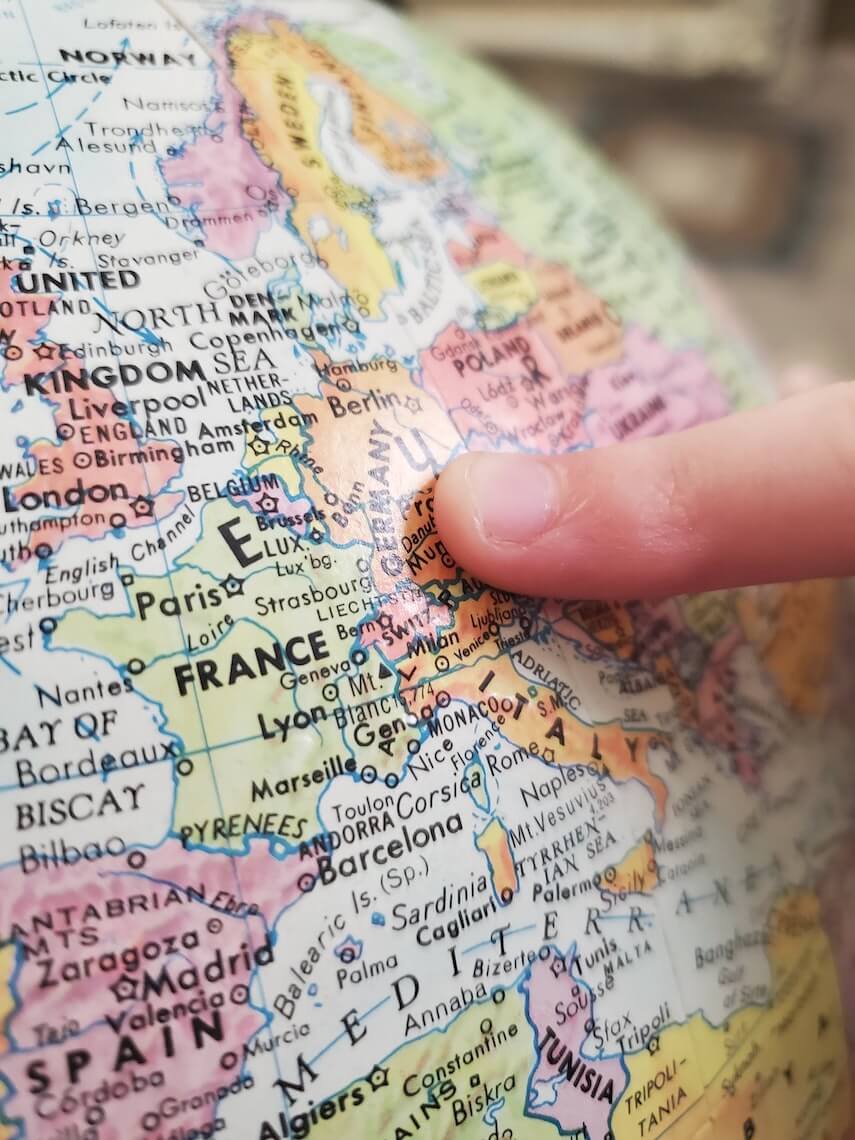 Europe map with finger pointing to Germany