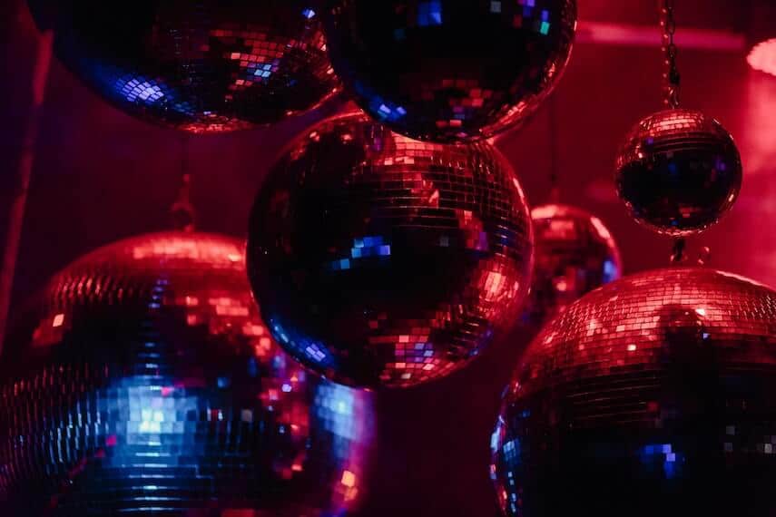 7 different size disco balls suspended from the ceiling