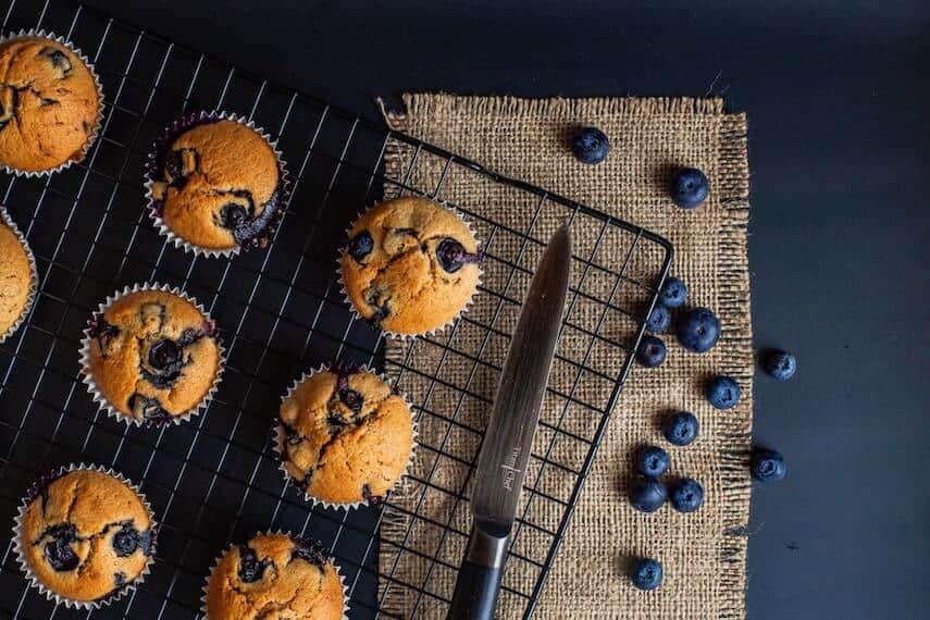 Blueberry cupcakes on a black wire rack