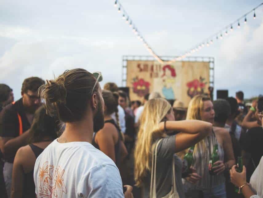 Crowd of people standing around at a festival