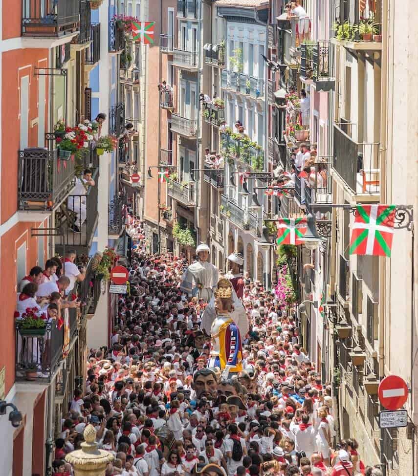 Crowd on the street between buildings at Pamplona