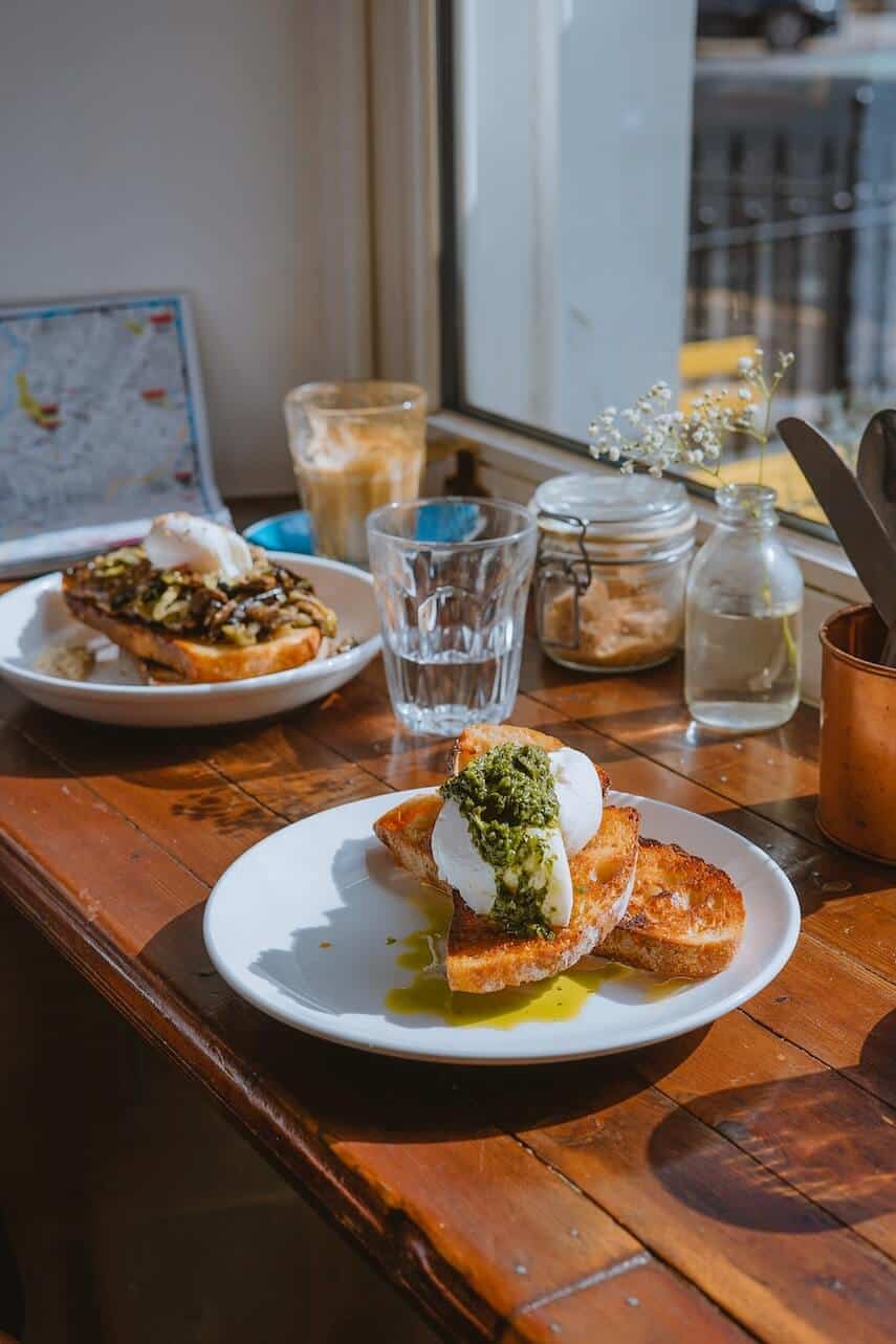 Two plates with poached eggs on sourdough toast