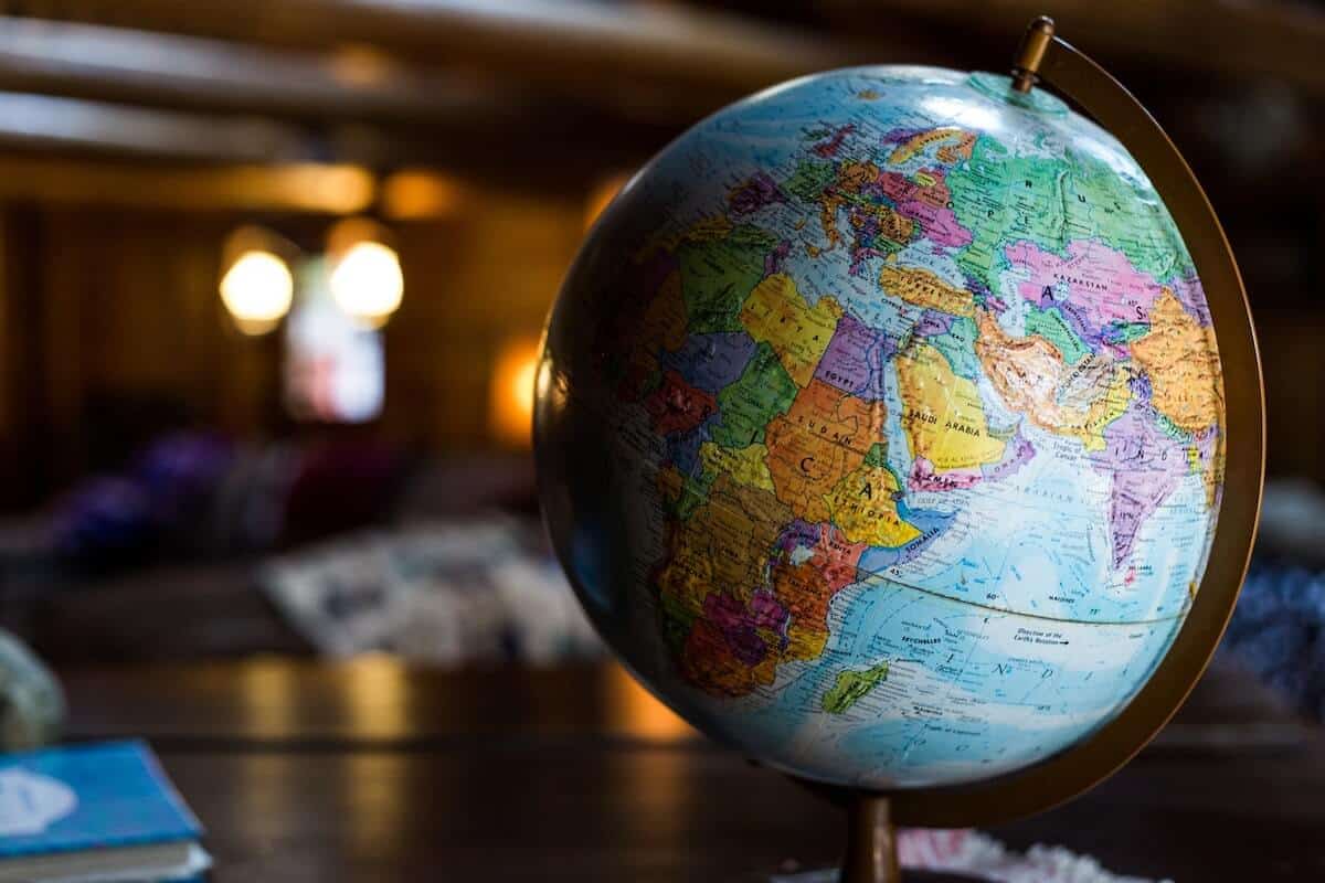 World Geography Quiz Questions and Answers cover photo of a plastic globe on a table