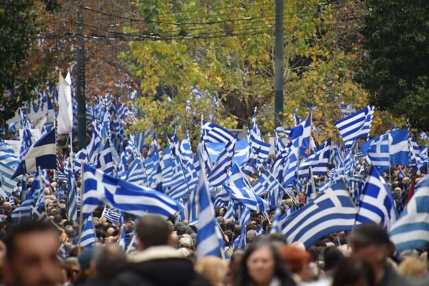Hundreds of people waving greek flags on Greece National Day