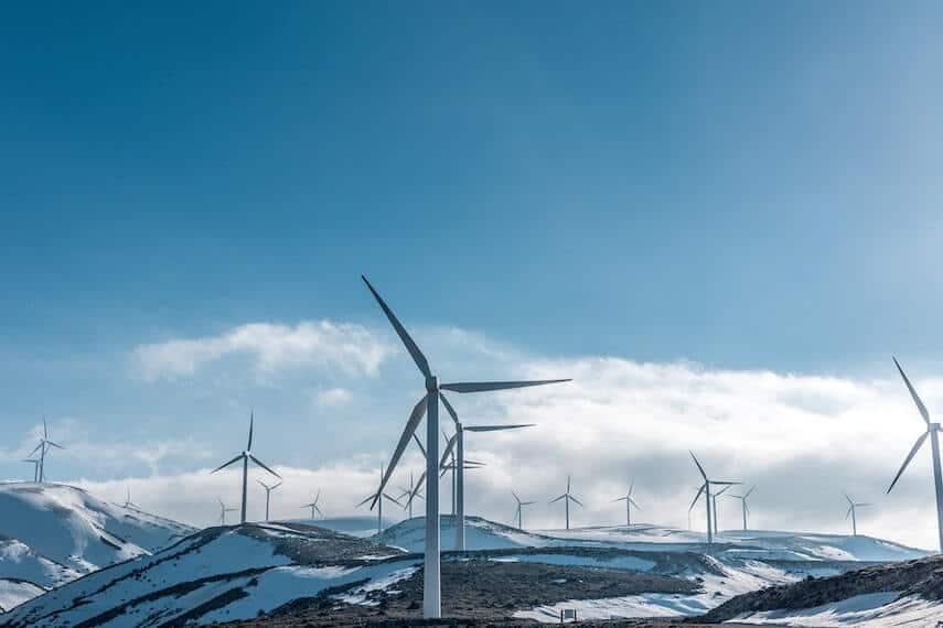 Wind turbines on snow covered hills