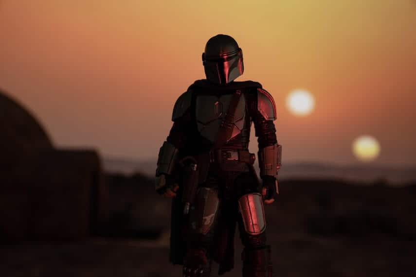 Mandalorian standing in front of a sunset