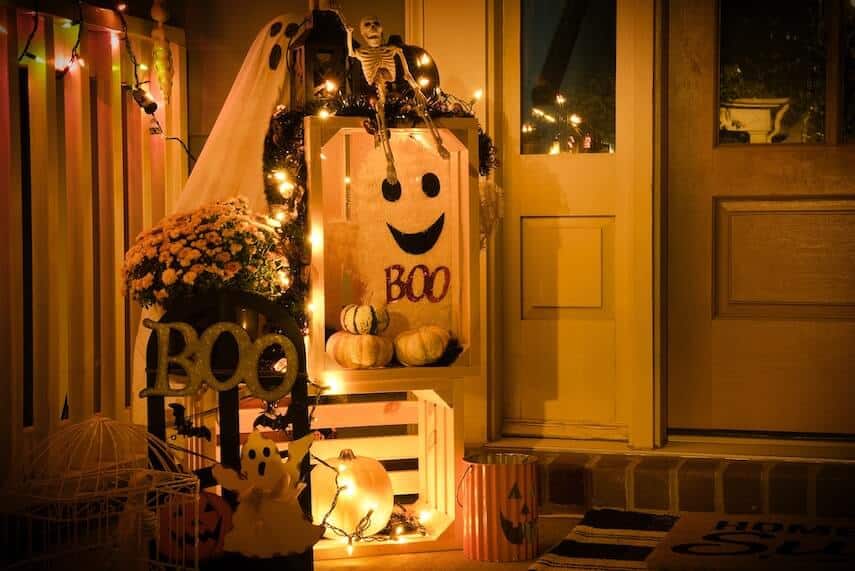 Front door decorated with halloween decorations and fairy lights